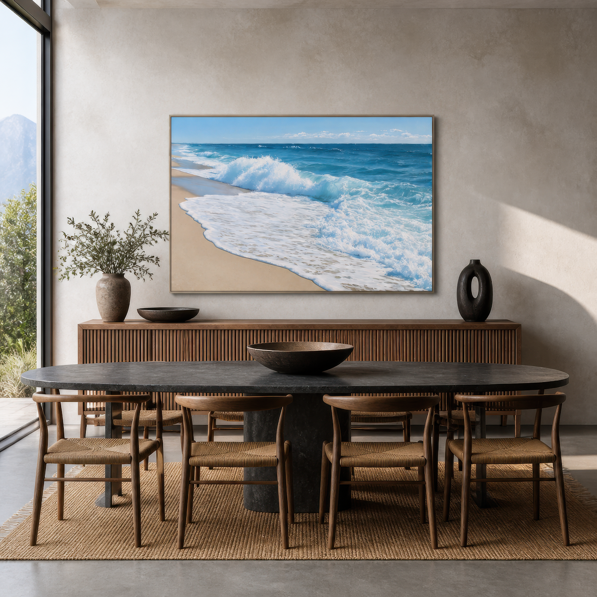 Wide breaking wave artwork above a ribbed wood sideboard in a dining room with a dark oval table