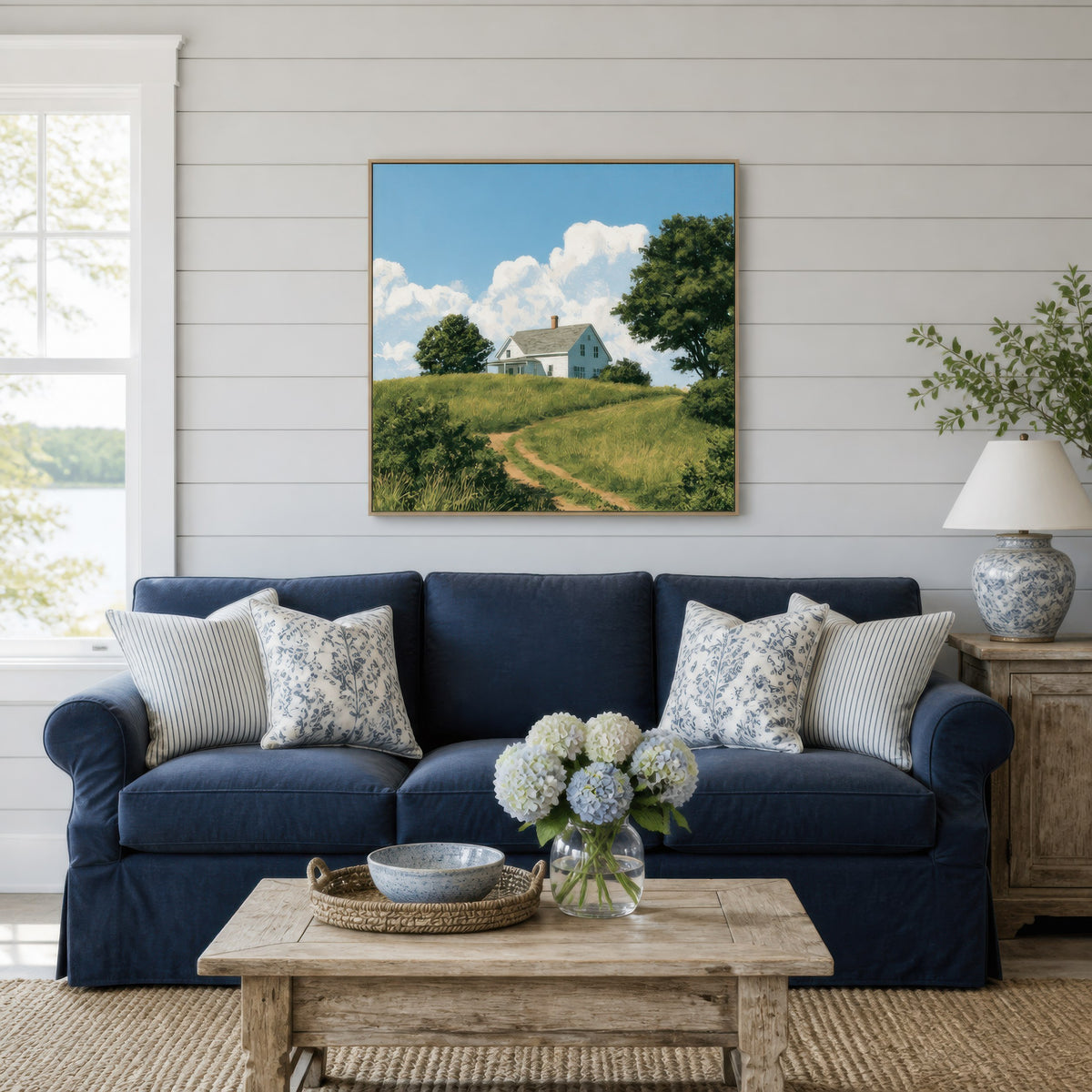 Hilltop farmhouse path above a navy blue sofa with patterned pillows on white shiplap