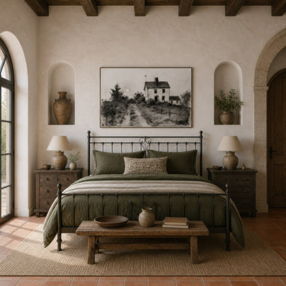 Dusty country road above a black iron bed with olive bedding and wooden nightstands