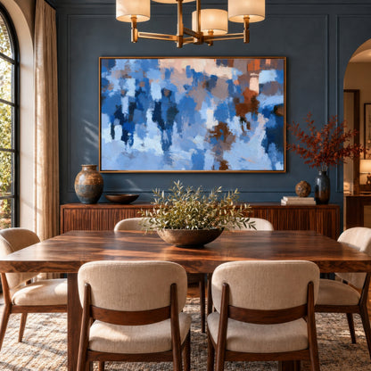 Blue crowd impression above a walnut dining table with cream chairs on a blue wall under a brass chandelier