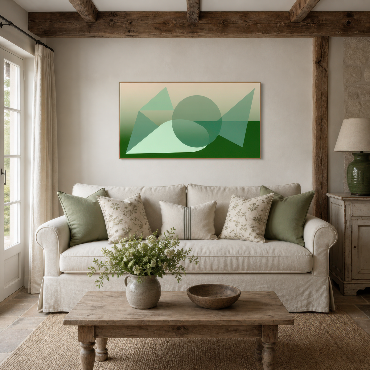 Wide green geometric abstract artwork above a white slipcovered sofa in a living room