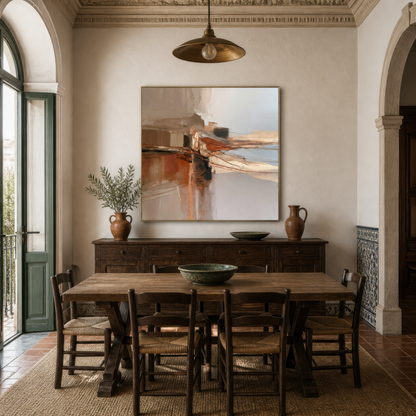 Square terracotta and gray abstract artwork above a sideboard in a dining room with a wooden table