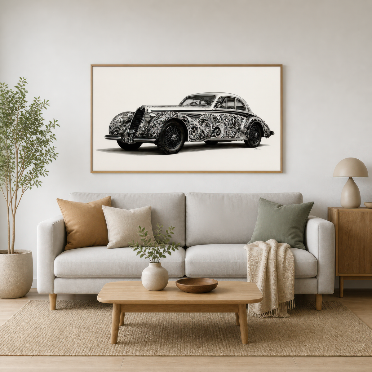 Vintage car in filigree above a white sofa with sage pillows and a pale wood coffee table