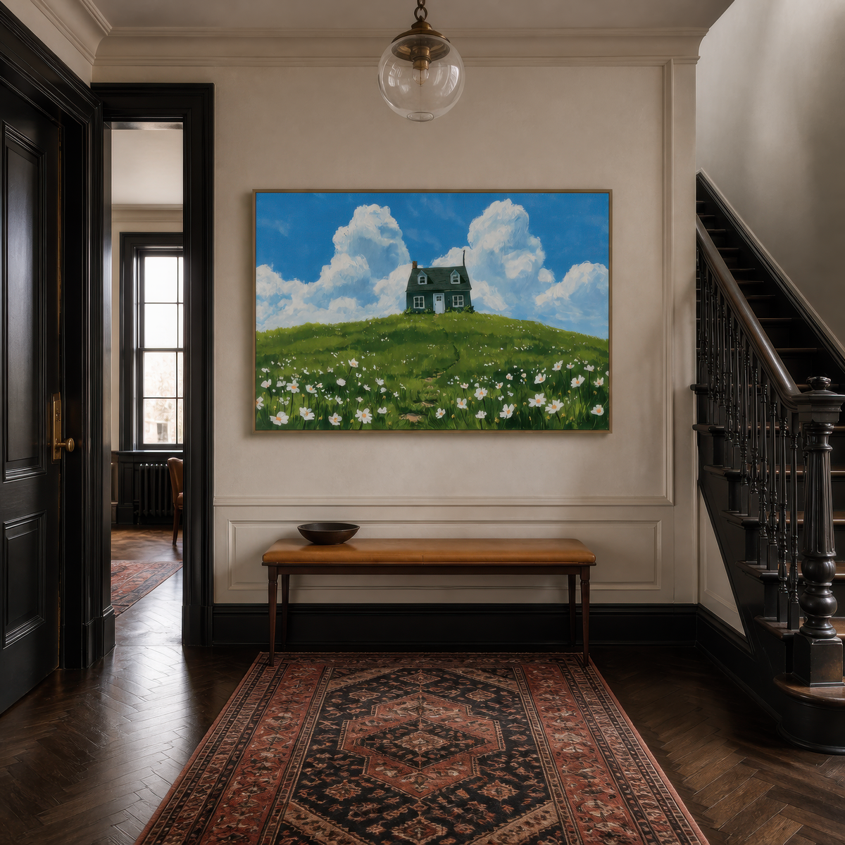 Cottage on the hill above a wooden console in an entryway with a red Persian runner