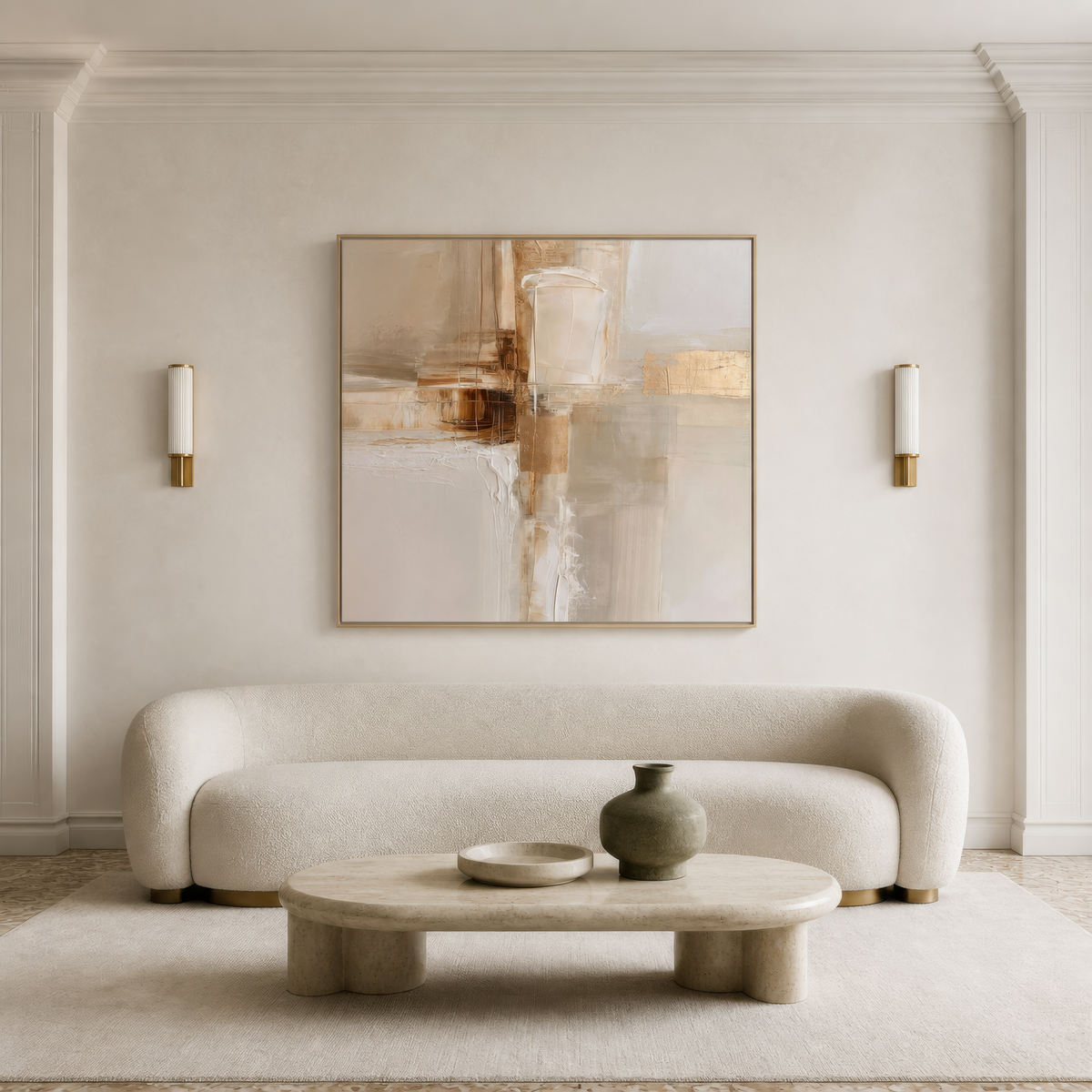 Square pale cream and gold abstract artwork above a curved white sofa between wall sconces