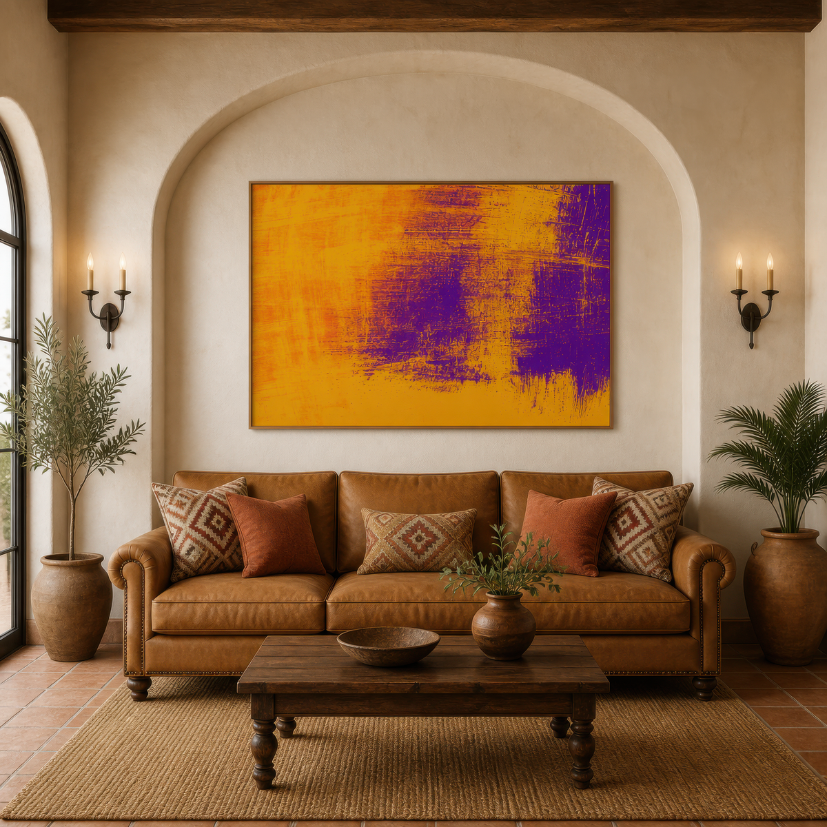Large mustard gold and purple abstract artwork above a tan leather sofa in an arched alcove with wall sconces