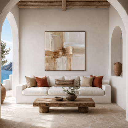 Square cream and copper abstract artwork above a white sofa beside an arched opening with a sea view