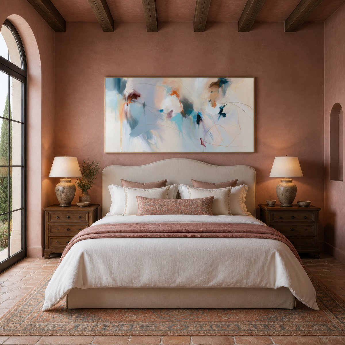 Wide soft blue and blush abstract artwork above an upholstered bed on a pink plaster wall