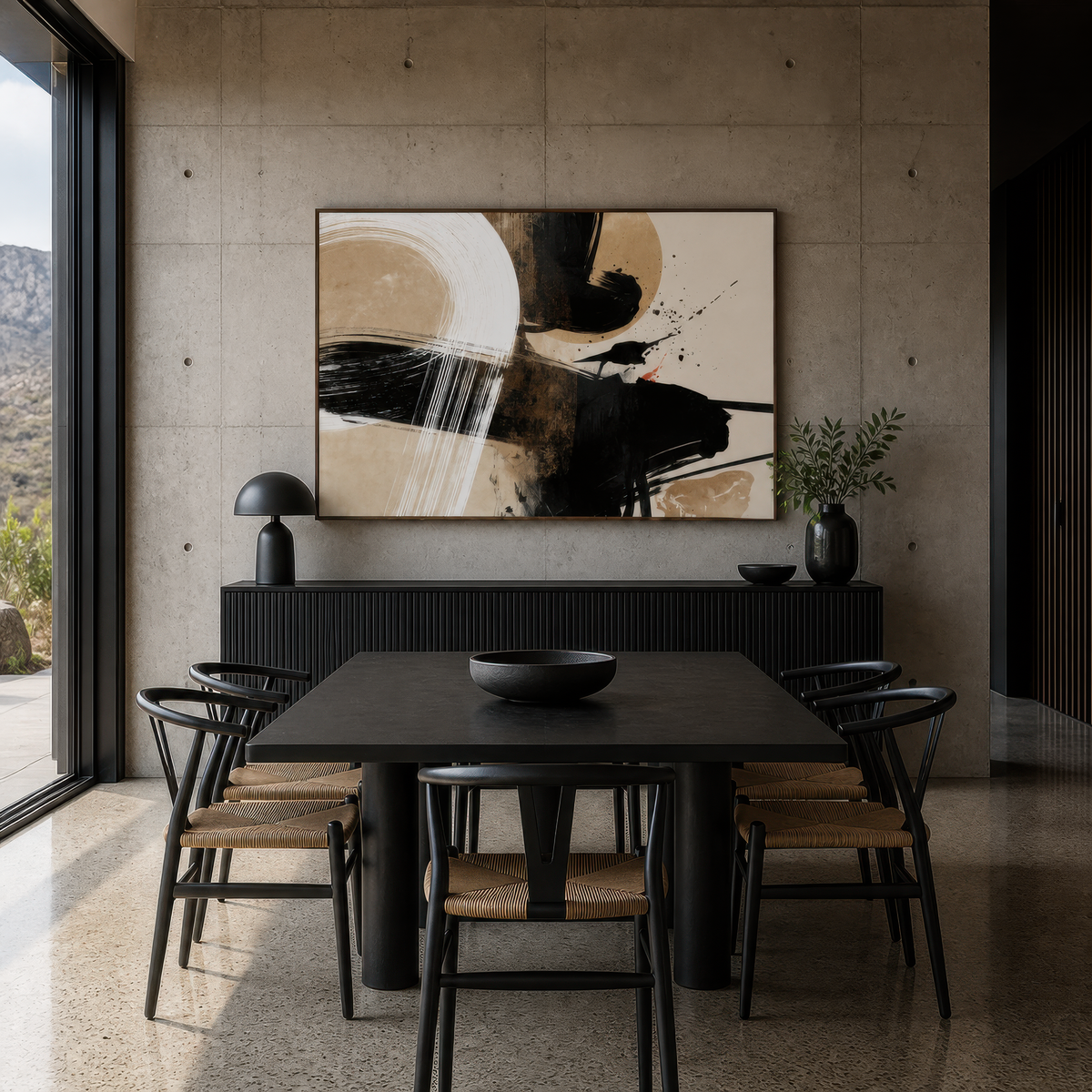 Sumi-e ink abstract above a black dining table with black chairs on a concrete wall
