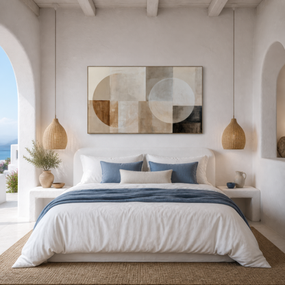 Wide neutral geometric abstract artwork above a bed with white and blue bedding in a white bedroom