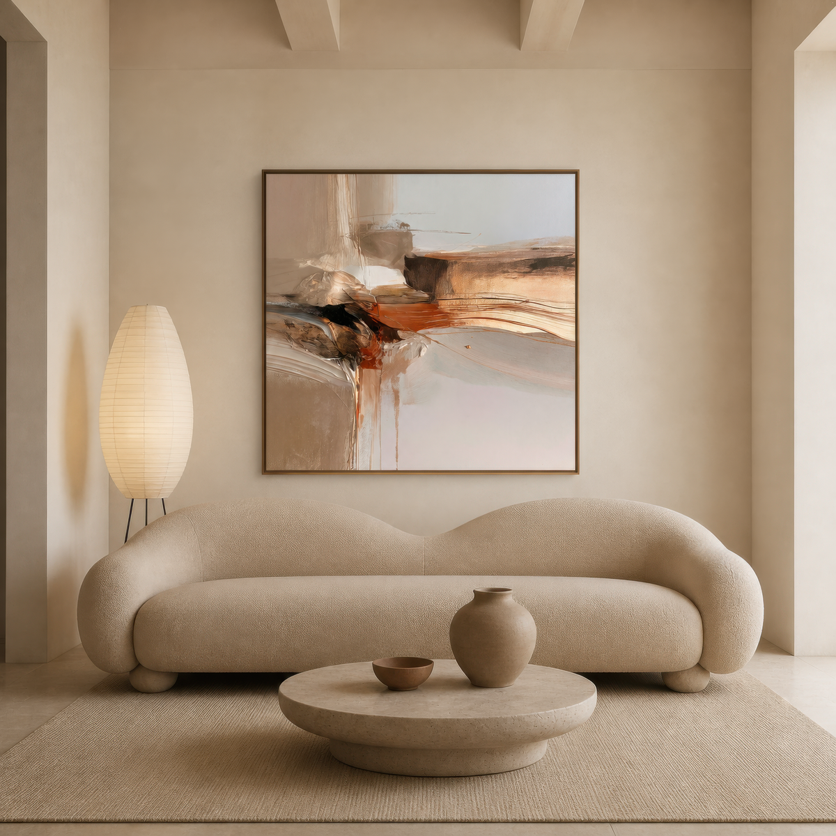 Square rust and black abstract artwork above a curved cream sofa with a paper floor lamp
