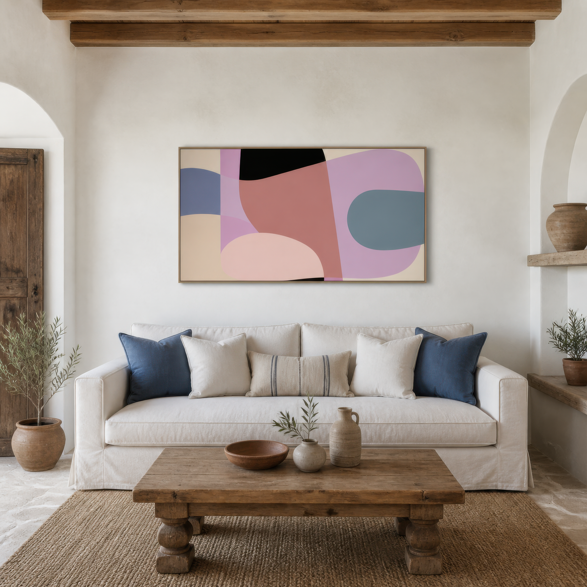 Wide mauve and lavender abstract artwork above a white sofa with navy pillows in a living room