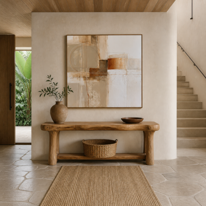 Square terracotta and cream abstract artwork above a wooden console table in an entryway beside stairs