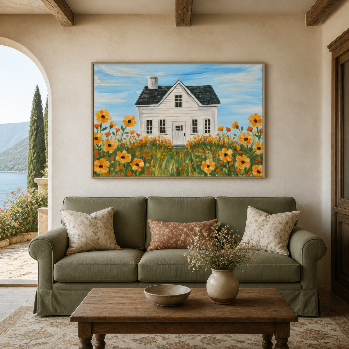 Golden meadow farmhouse above a sage green sofa with floral pillows beside an arched window