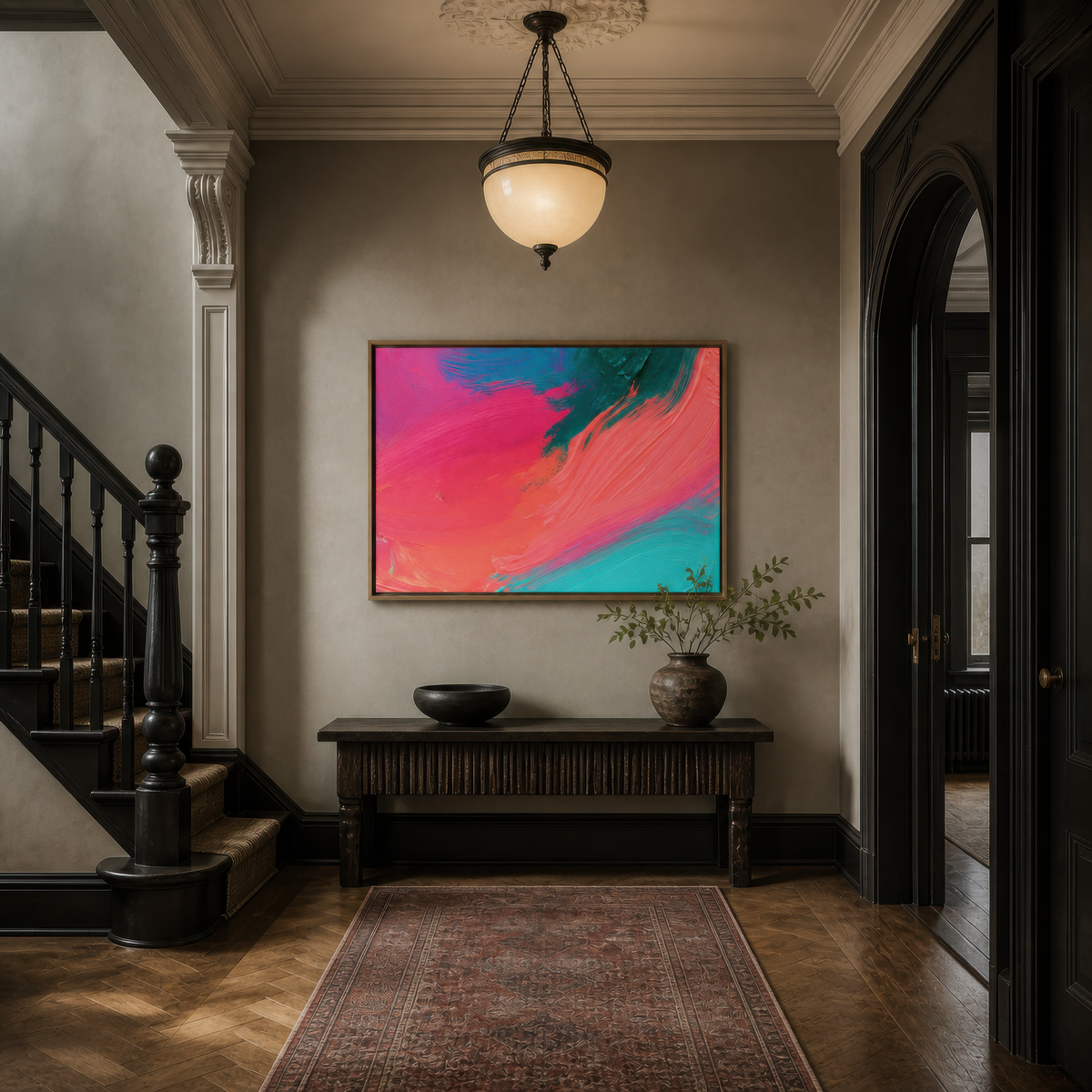 Large pink and turquoise brushstroke abstract artwork above a dark console in an entryway beside a staircase