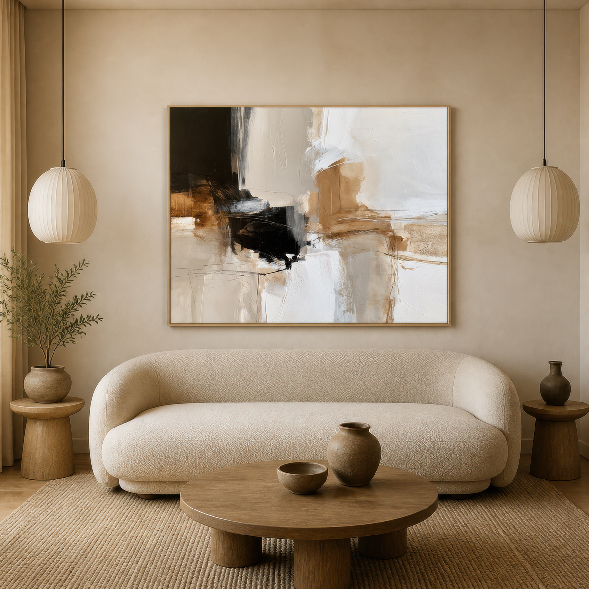 Large black and beige abstract artwork above a curved white sofa between paper lanterns