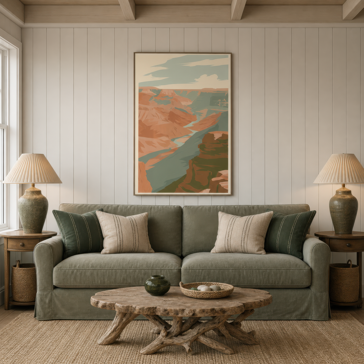 Wide canyon vista above a sage green sofa on a white plank wall with two lamps