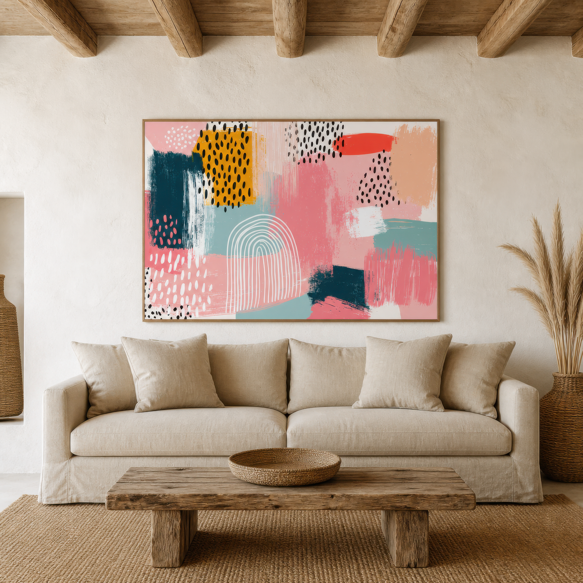 Memphis pink and navy collage artwork above a cream sofa in a plaster room with wood beams
