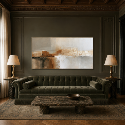 Wide terracotta and gray abstract artwork above a dark green tufted sofa on a dark paneled wall