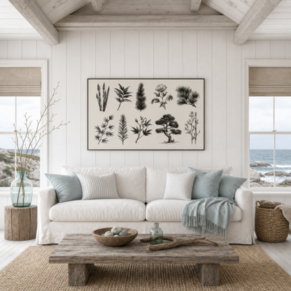 Japanese botanical chart above a white slipcovered sofa with blue pillows and a wood table