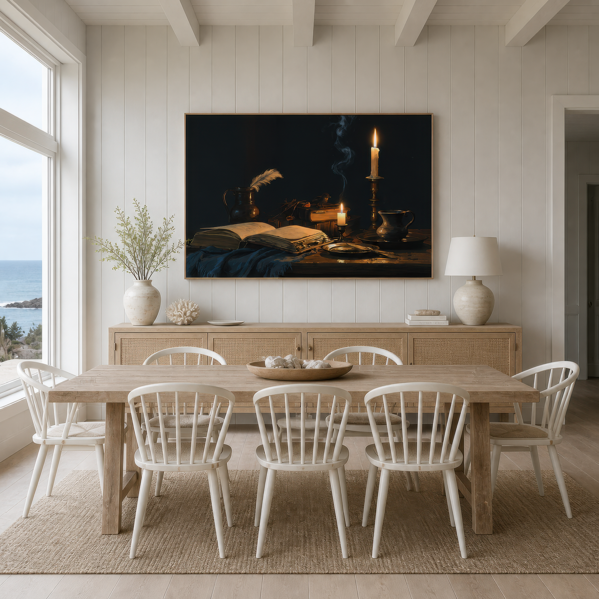 Brass and ink above a pale wood dining table with white spindle chairs on white shiplap