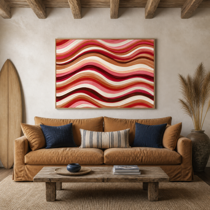Dusty rose wave band artwork above a tan leather sofa with navy pillows and a wood table