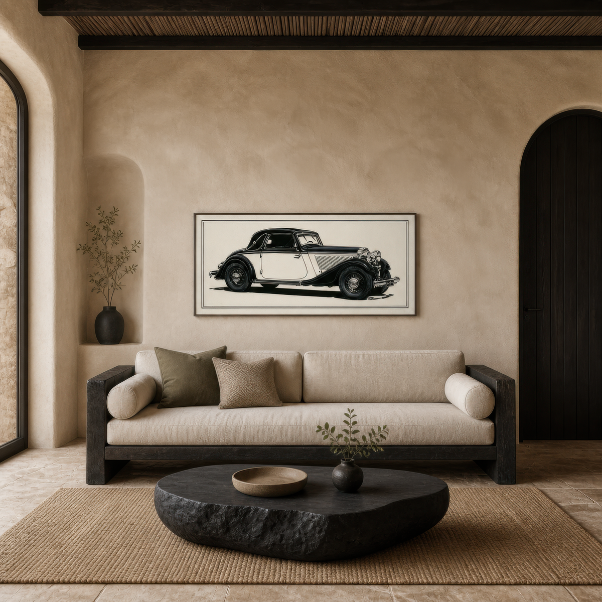 Vintage coupe sketch above a long cream sofa on a plaster wall with a black stone table