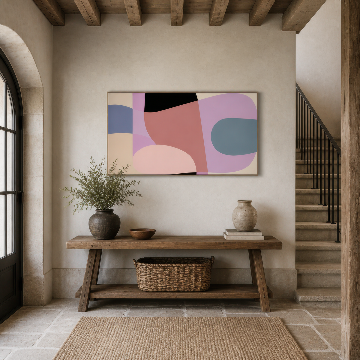 Wide mauve and lavender abstract artwork above a wooden console table in an entryway beside a staircase