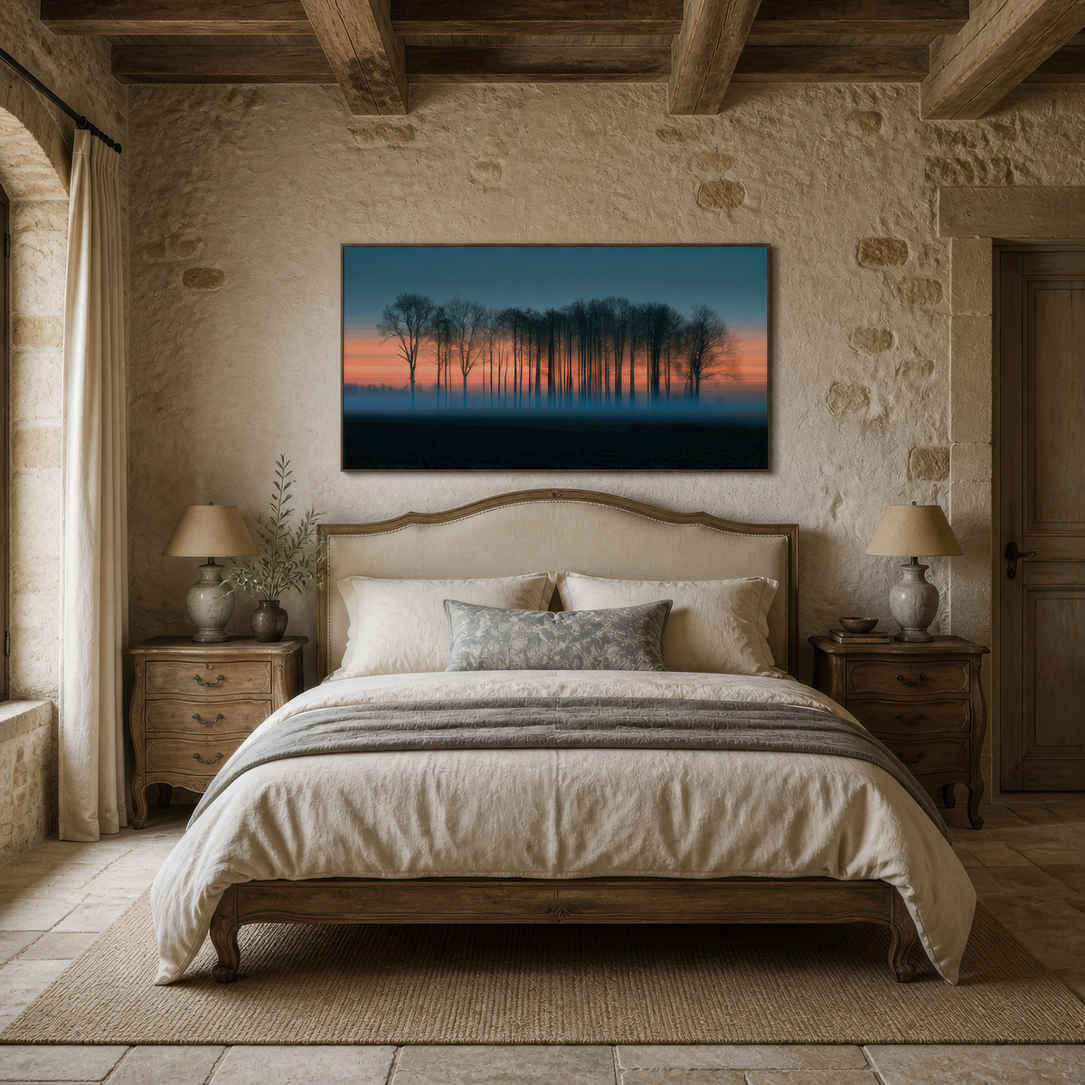 Misty treeline at dusk above an upholstered bed on a rough stone wall with two lamps