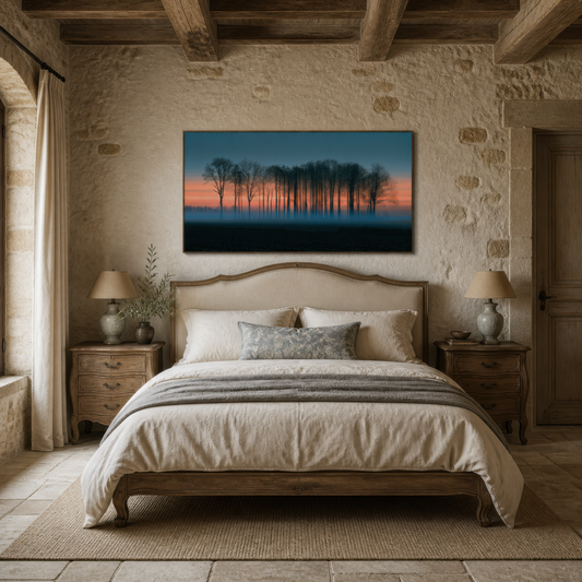 Misty treeline at dusk above an upholstered bed on a rough stone wall with two lamps