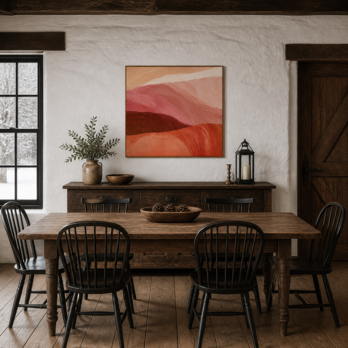 Rolling hills at dusk artwork above a dark dining table with black spindle chairs