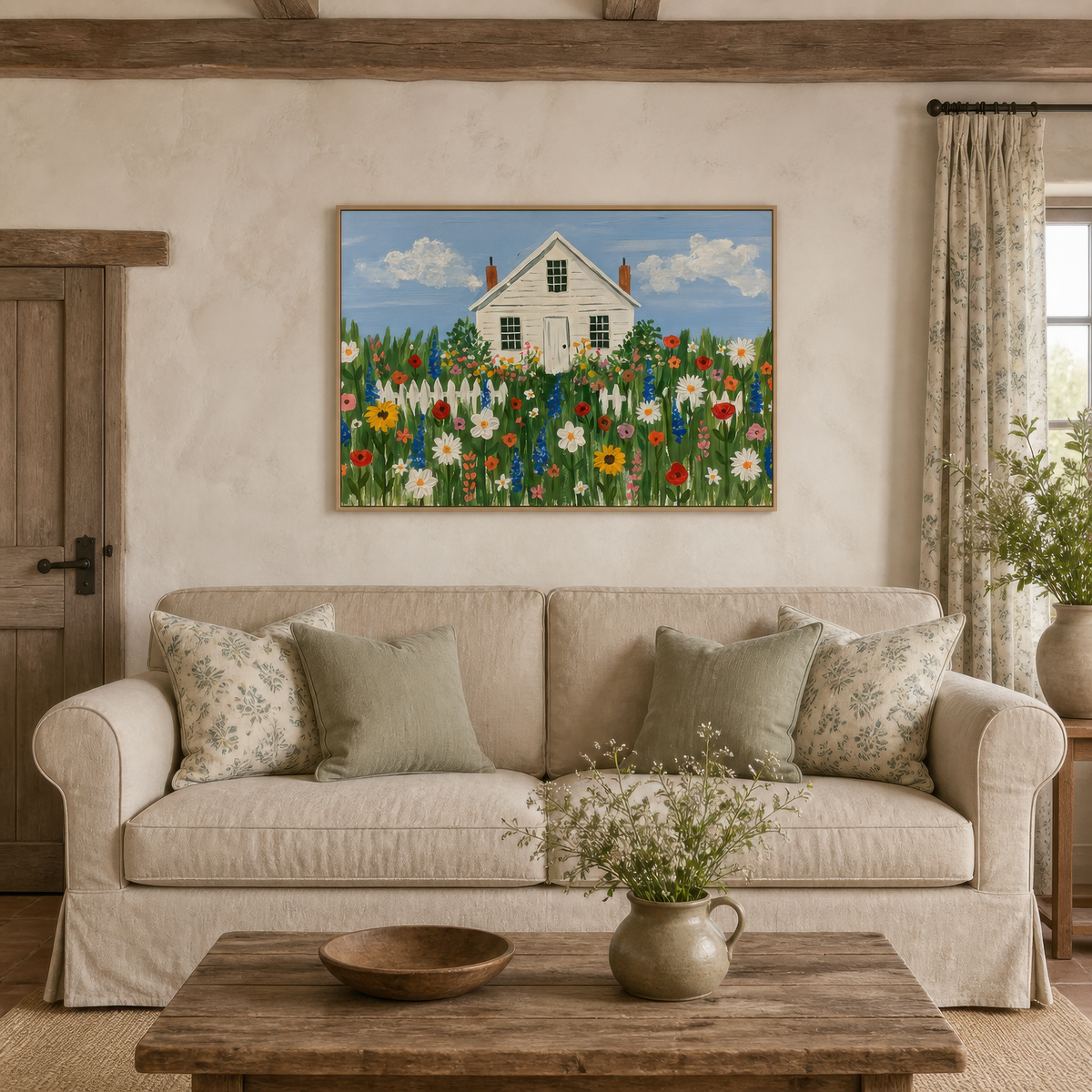 Wildflower cottage above a white slipcovered sofa with sage pillows and a wooden table