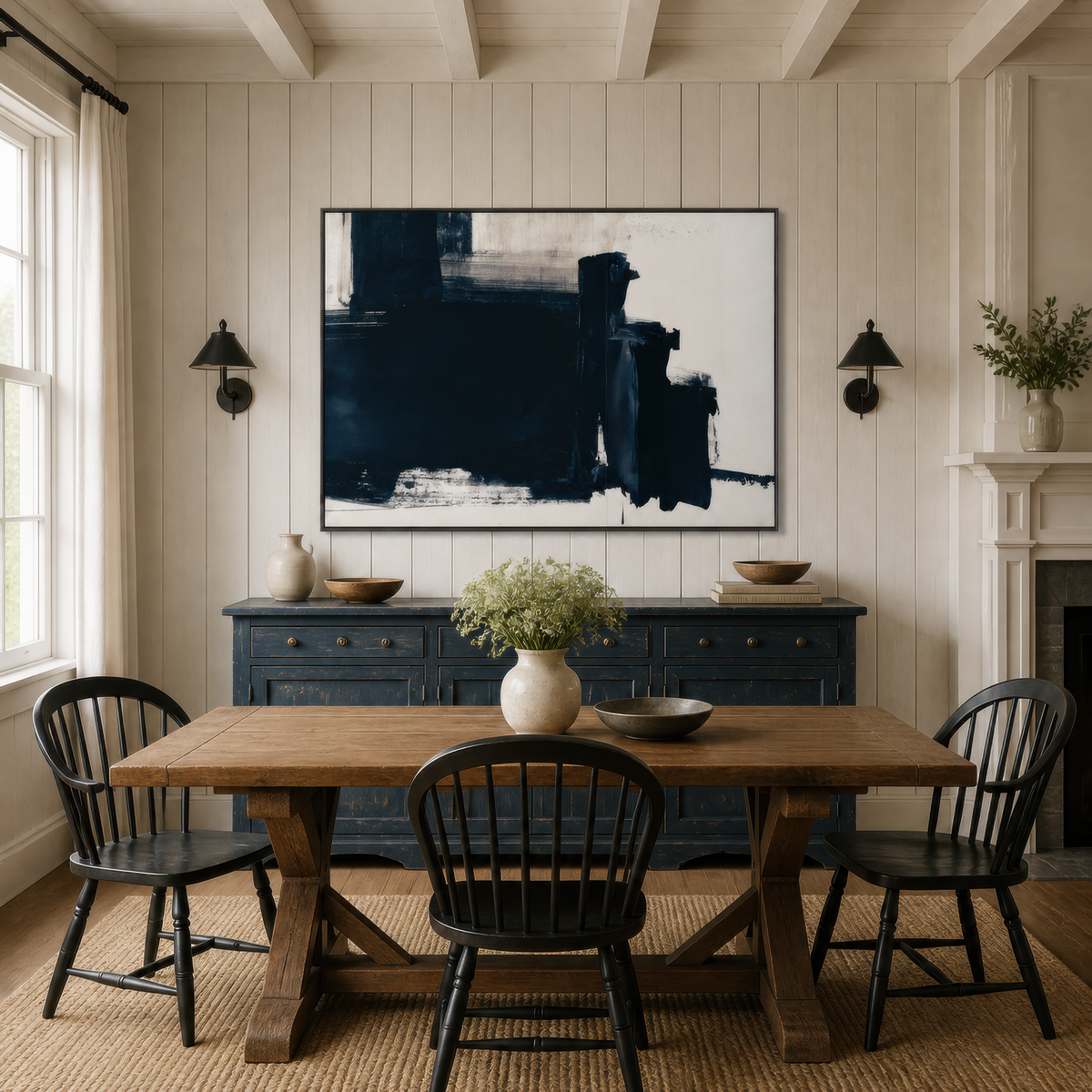 Large black and navy abstract artwork above a navy sideboard in a dining room with a wooden table