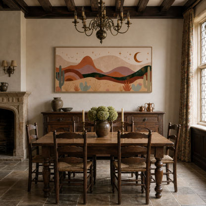 Desert night mountains above a dark wood dining table with spindle chairs and a chandelier