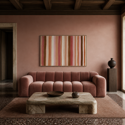 Terracotta and rose stripe artwork above a mauve channel-tufted sofa on a dusty rose wall