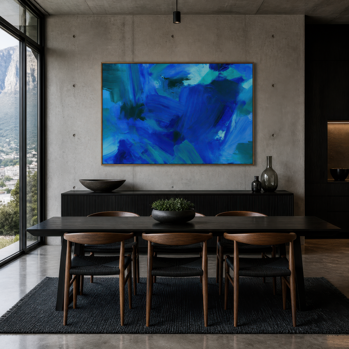 Cobalt brushstroke abstract above a dark dining table with wishbone chairs and a sideboard