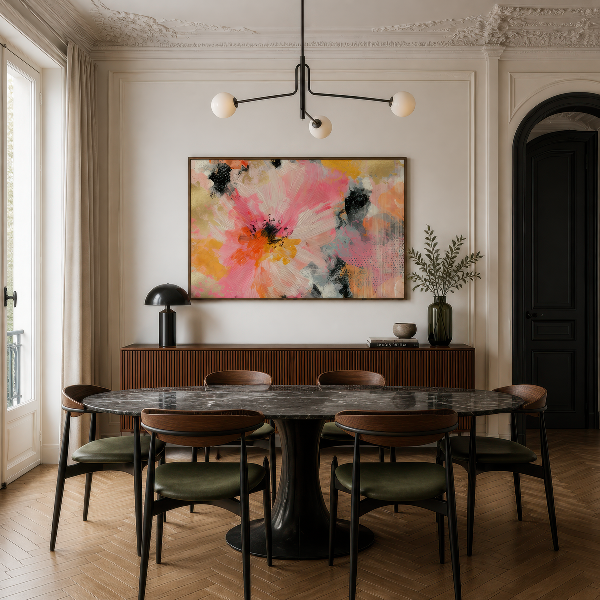 Pink and gold abstract bloom above a dark round dining table with a globe chandelier