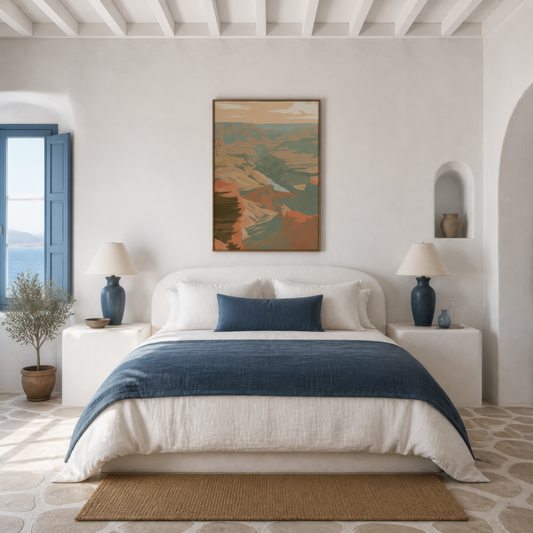 Layered canyon ridges above a white bed with a navy runner on a plaster wall