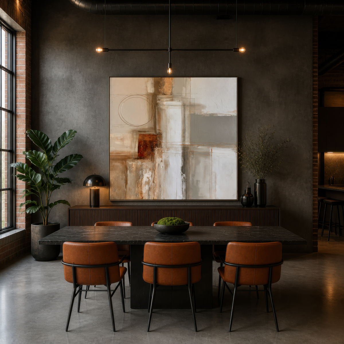 Square rust and cream abstract artwork above a dark dining table with leather chairs on a concrete floor