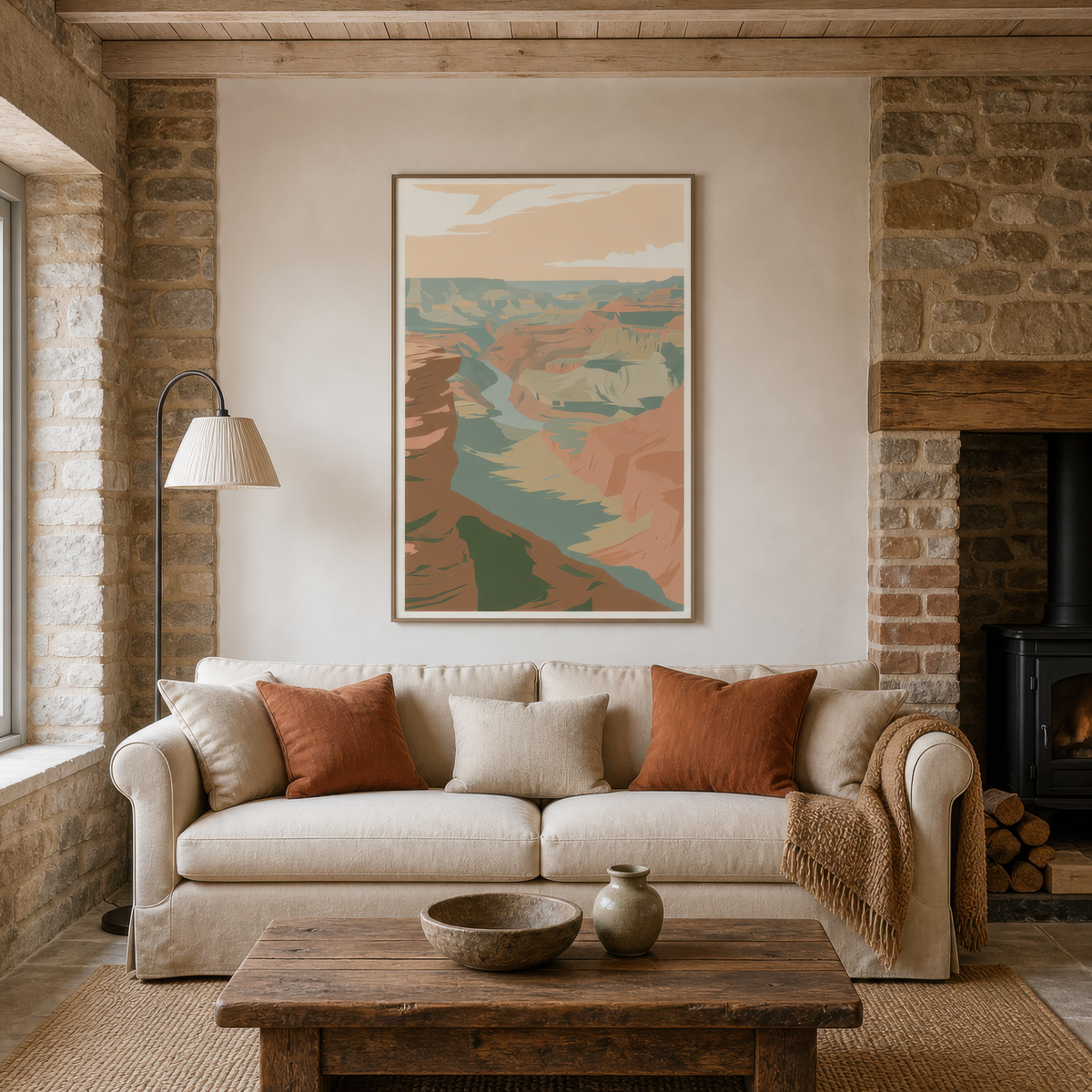 Golden canyon illustration above a cream sofa with rust pillows by a wood stove