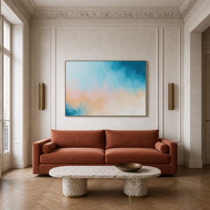 Large soft teal and apricot abstract artwork above a rust velvet sofa in a paneled living room